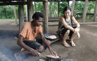 missionary watches as a friend cooks under her house