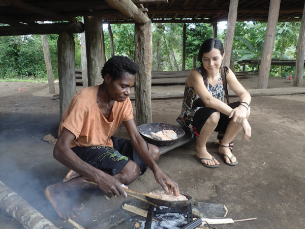 missionary watches as a friend cooks under her house