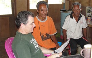 Bob Clark and two Tugutil men translating the Bible