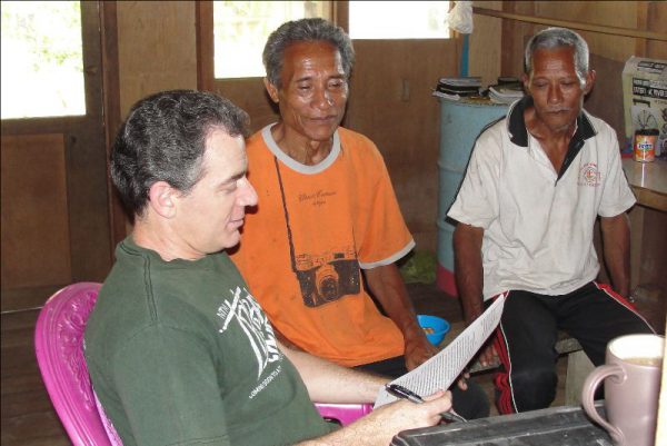 Bob Clark and two Tugutil men translating the Bible