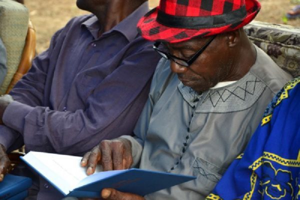 man reading book at an event