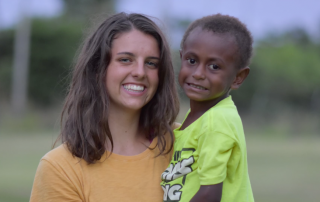 Interface student holding a Papua New Guinean boy