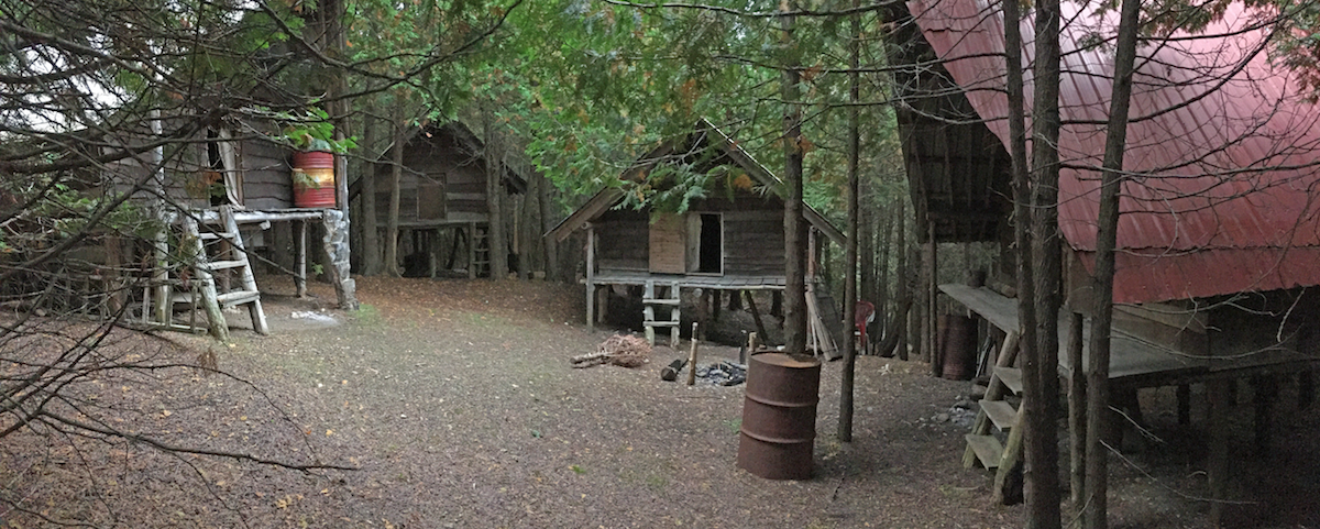 rustic huts make a mock-village in the woods