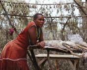 Tanzanian woman selling bracelets