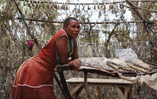 Tanzanian woman selling bracelets