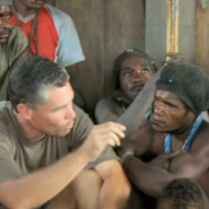 missionary sitting with men from Asia Pacific and teaching them