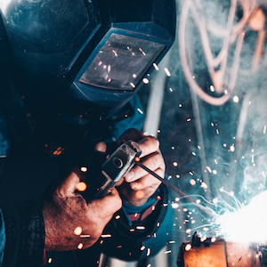 a man welding showing how all skills are needed in missions