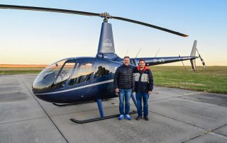 pilots standing by new helicopter before leaving for Brazil