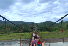 Encounter participants crossing a rope bridge