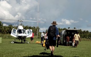 people preparing for a helicopter flight