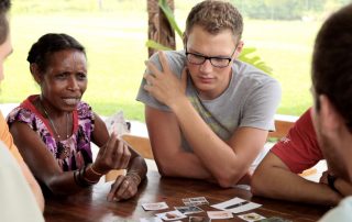 students studying language with a Papua New Guinea woman