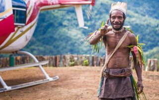 Papua New Guinea man standing by a helicopter