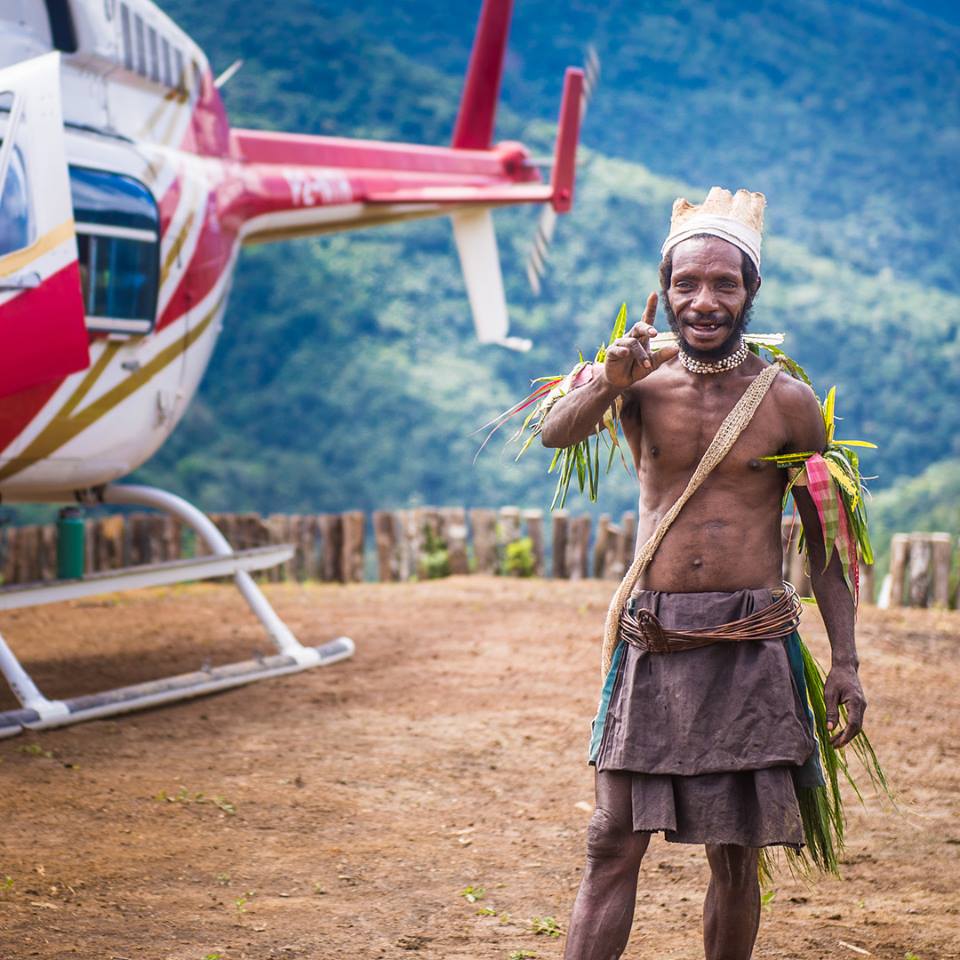 Papua New Guinea man standing by a helicopter