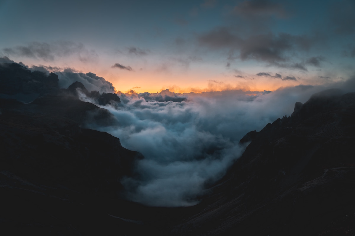 clouds and sunlight through a mountainous valley