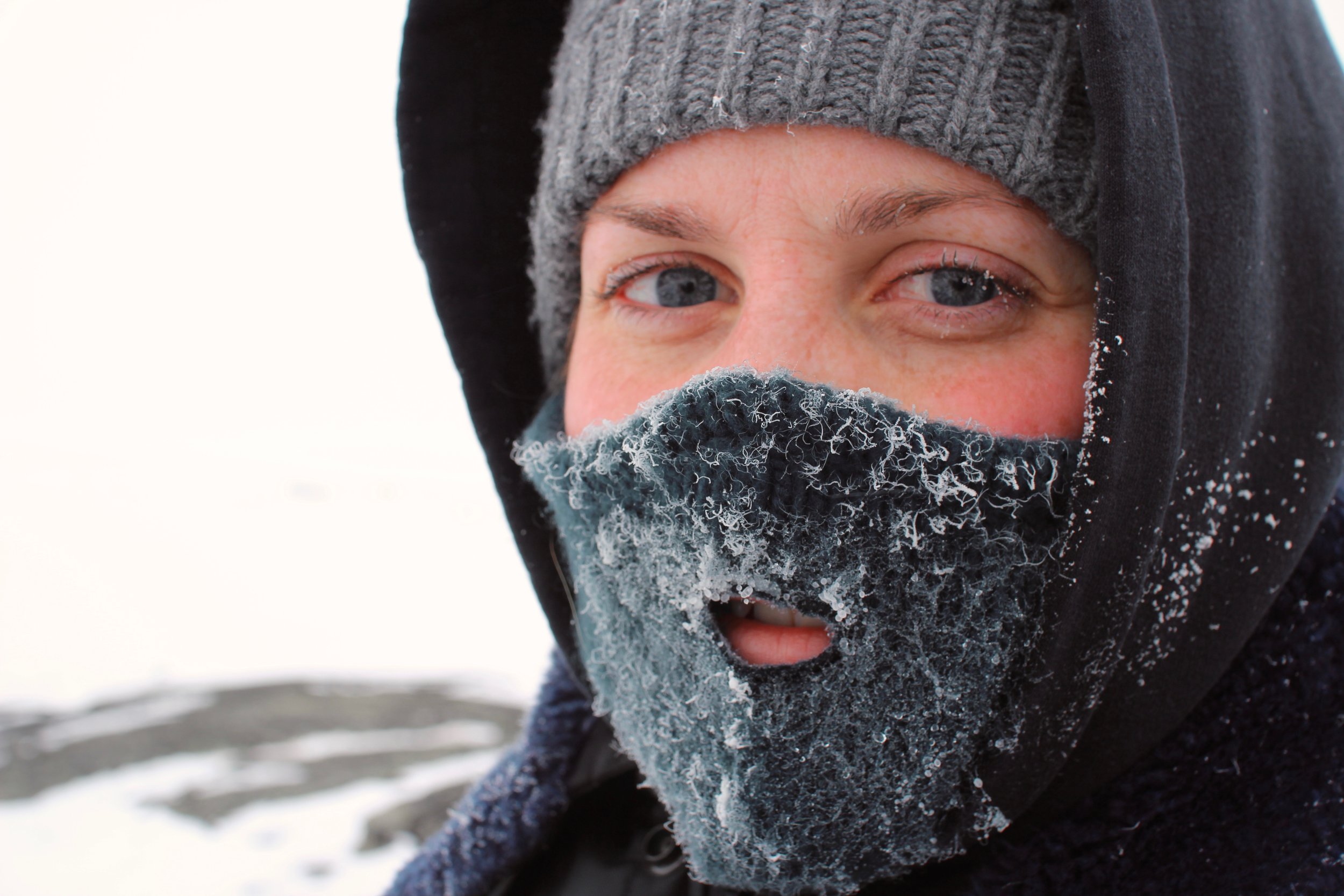 woman wearing hat, hood and mask against the cold