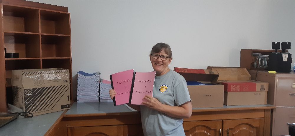 a missionary holding up newly printed books