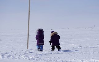 two kids walking outside in the far north