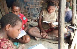 Moi women studying the Bible in their own language