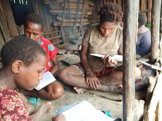 Moi women studying the Bible in their own language