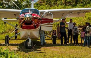 tribal people gathered to welcome missionaries at the air strip