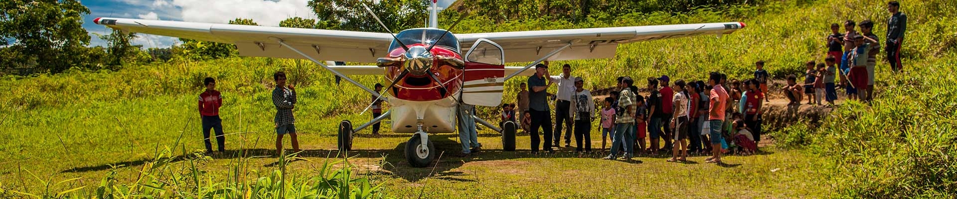 tribal people gathered to welcome missionaries at the air strip