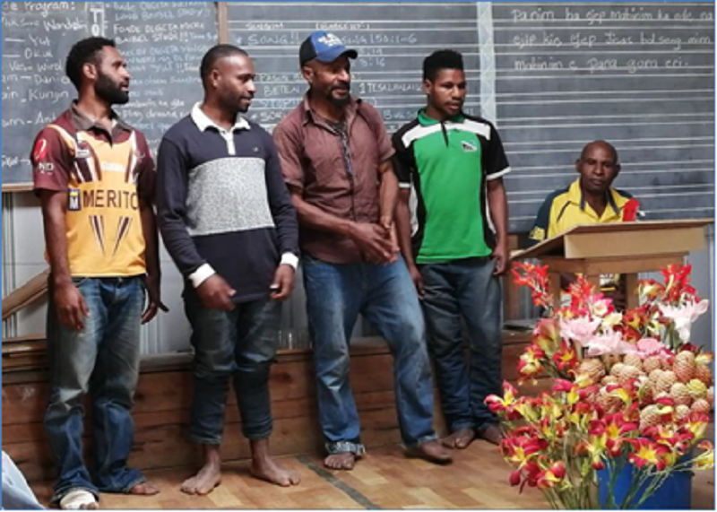 Wahgi men standing by chalk board