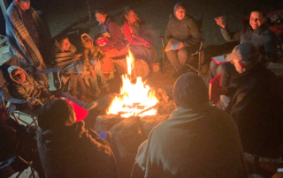 people meeting around campfire