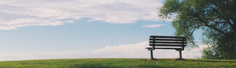 empty bench on a sunny hill