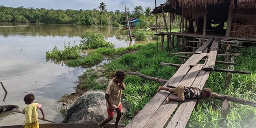 Asmat kids on the boardwalk and in a canoe