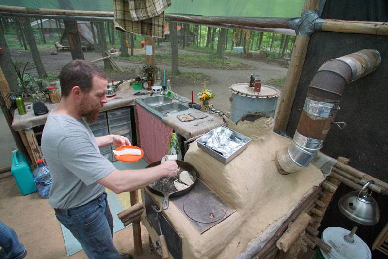 man at a clay stove